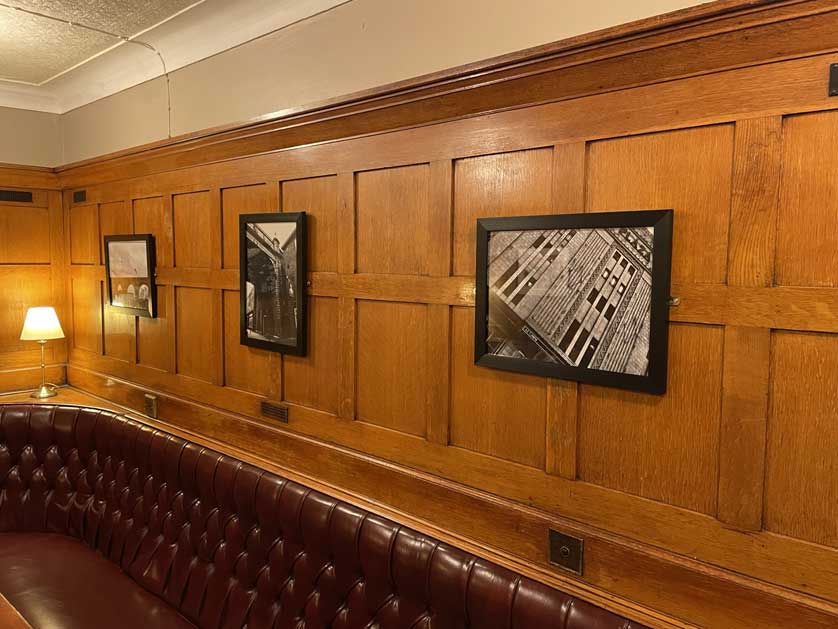Black and white photographs of Stockport adorn the wood paneled walls.