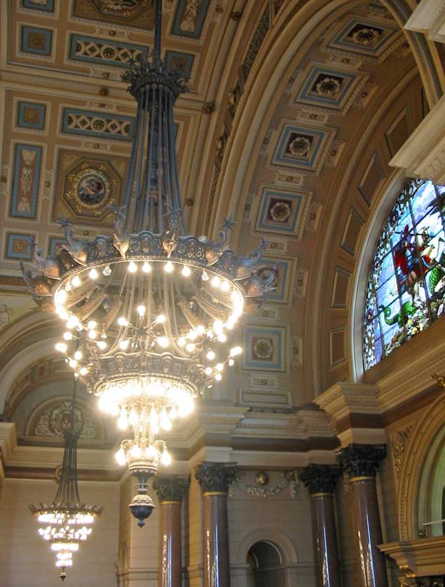 One of the ten chandeliers, brass and bronze, decorated with prows of ships, heads of Neptune and Liver Birds.